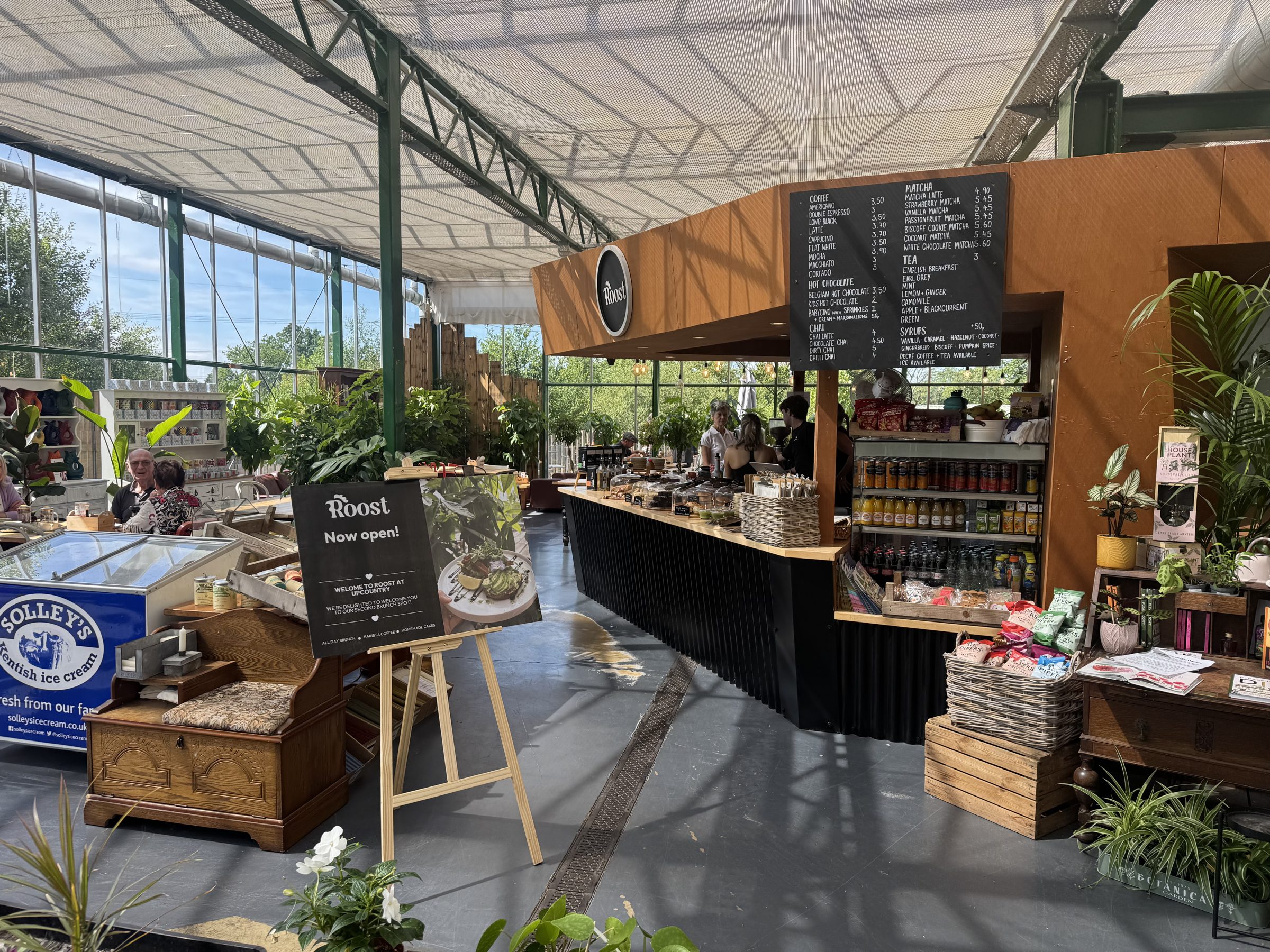 The glasshouse cafe counter at Upcountry, cakes under glass in natural light